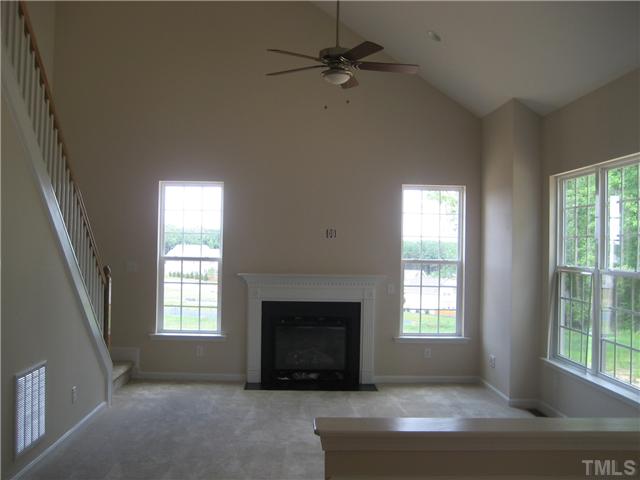 242 Forbes Road, Unit LOT16 Wake Forest, NC 27587 - Photo 5 of 12 Large family room features a gas log fireplace, triple box bay window and cathedral ceiling. The second staircase leads from the family room to the three, secondary bedrooms above!