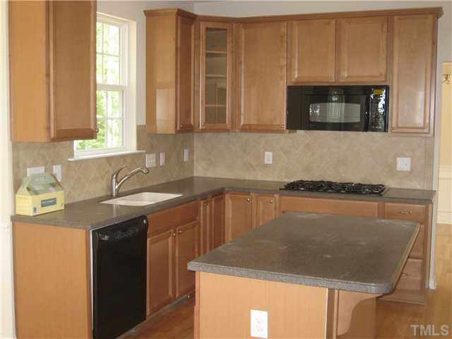 242 Forbes Road, Unit LOT16 Wake Forest, NC 27587 - Photo 6 of 12 Beautiful maple cabinets and durable Corian counters with an easy to clean, integrated sink. 36" gas, 5-burner, cooktop and double built-in wall ovens with a large island make this a kitchen to really enjoy cooking in!