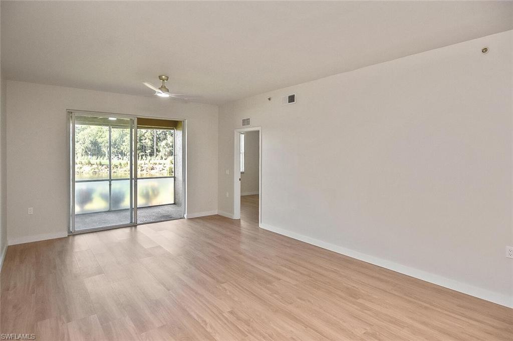 3830 Sawgrass Way, Unit 2914 Naples, FL 34112 - Photo 1 of 50 wooden floor in an empty room with a window