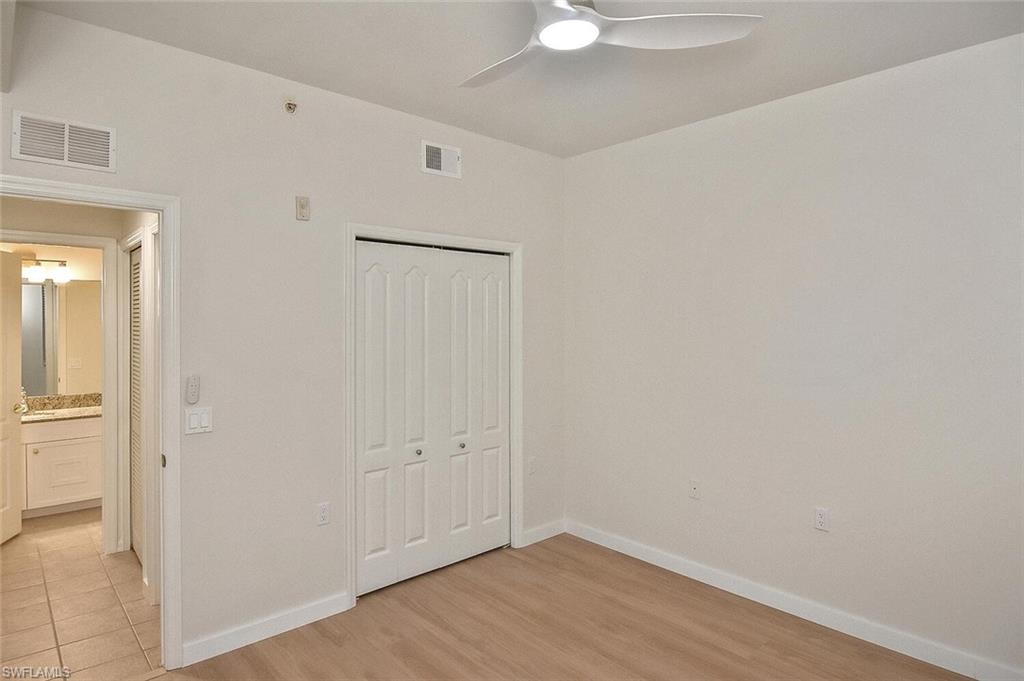 3830 Sawgrass Way, Unit 2914 Naples, FL 34112 - Photo 11 of 50 an empty room with wooden floor