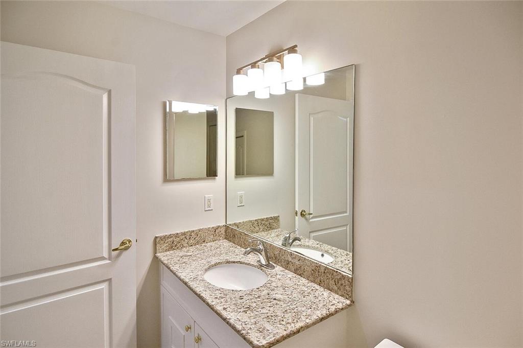 3830 Sawgrass Way, Unit 2914 Naples, FL 34112 - Photo 16 of 50 a bathroom with a granite countertop sink and a mirror