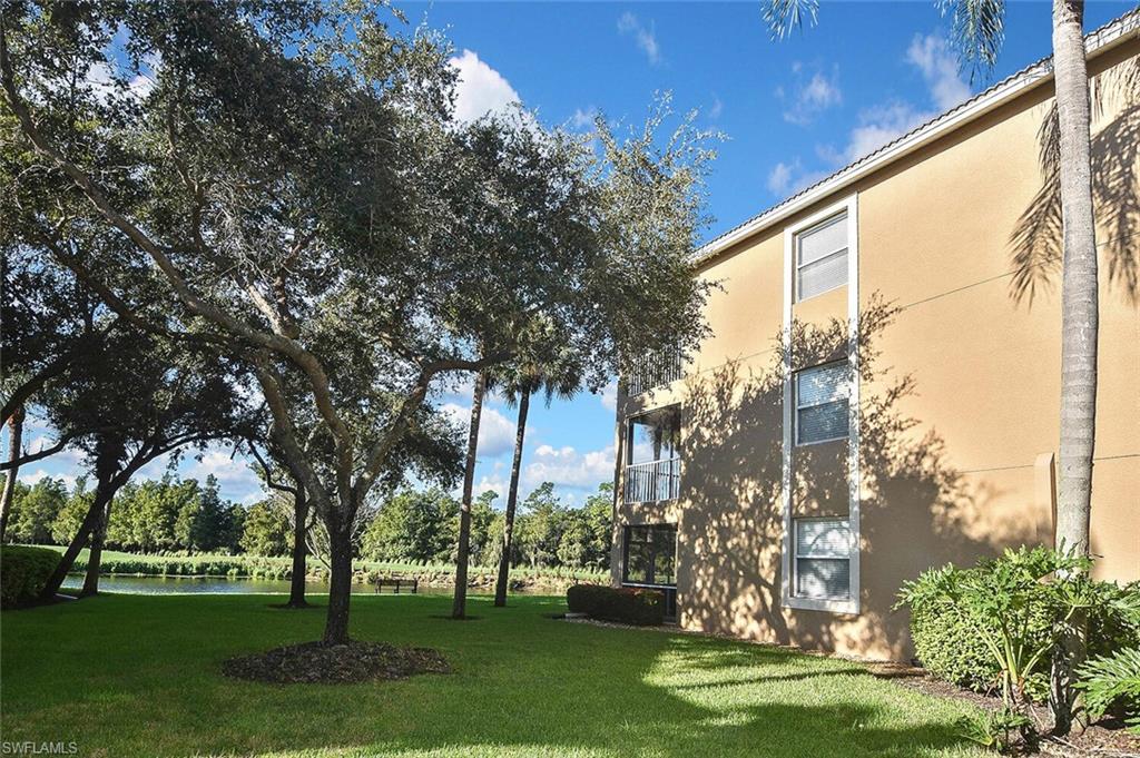 3830 Sawgrass Way, Unit 2914 Naples, FL 34112 - Photo 2 of 50 a view of a big yard and a large tree