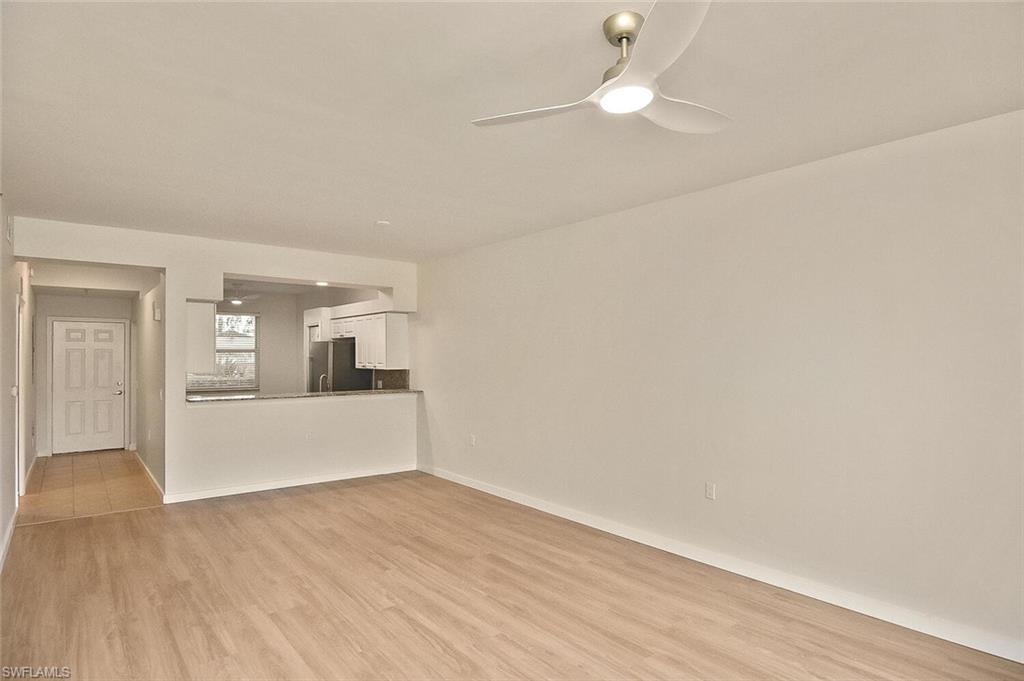 3830 Sawgrass Way, Unit 2914 Naples, FL 34112 - Photo 26 of 50 a view of a kitchen with wooden floor and a ceiling fan