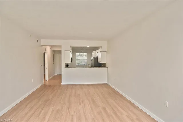 a view of a kitchen with wooden floor and a kitchen