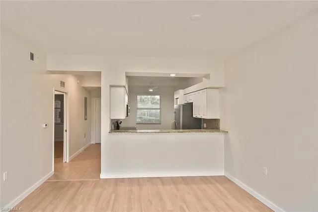 a view of a kitchen with a sink and a refrigerator