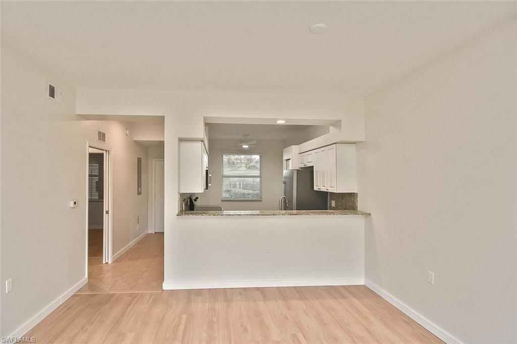 3830 Sawgrass Way, Unit 2914 Naples, FL 34112 - Photo 28 of 50 a view of a kitchen with a sink and a refrigerator