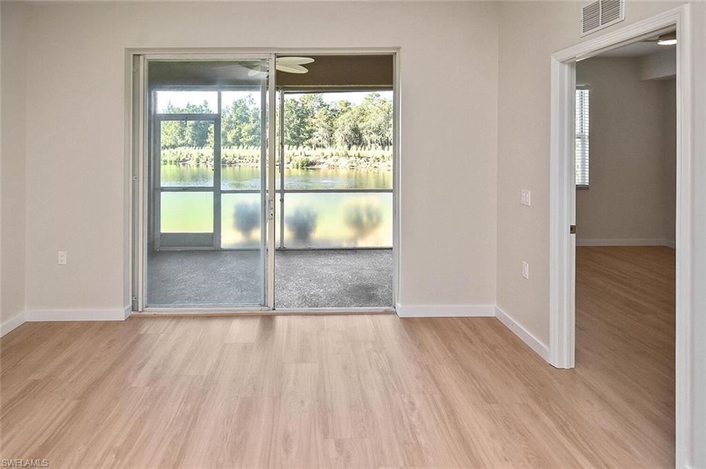 3830 Sawgrass Way, Unit 2914 Naples, FL 34112 - Photo 37 of 50 a view of empty room with wooden floor and fan
