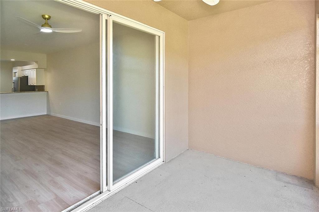 3830 Sawgrass Way, Unit 2914 Naples, FL 34112 - Photo 40 of 50 an empty room with wooden floor and a bathroom