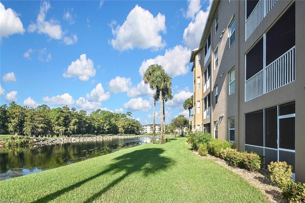 3830 Sawgrass Way, Unit 2914 Naples, FL 34112 - Photo 48 of 50 a view of a lake with a building in the background