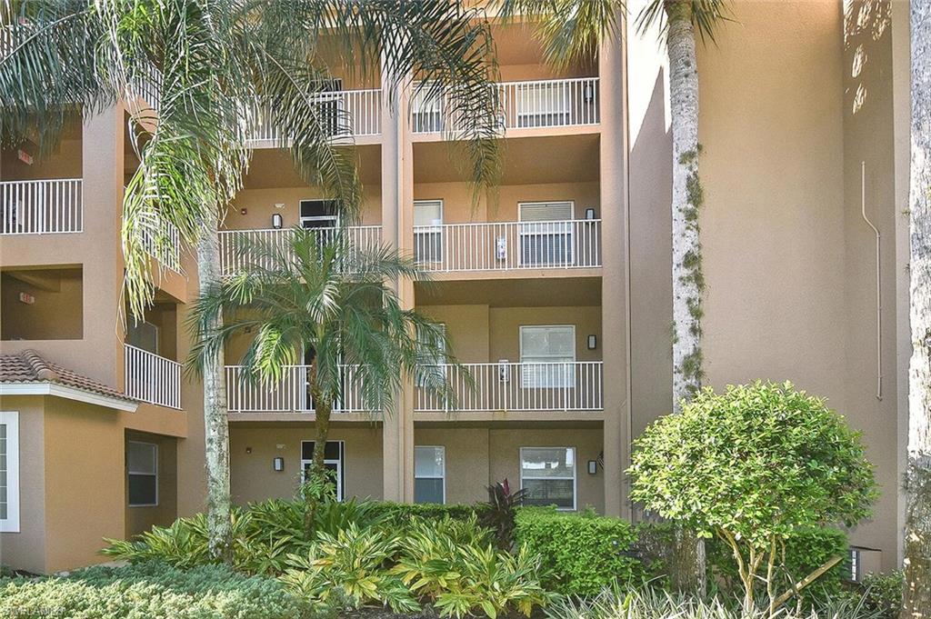 3830 Sawgrass Way, Unit 2914 Naples, FL 34112 - Photo 6 of 50 a front view of a house with a garden