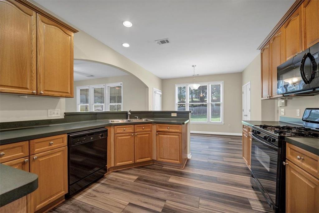 501 Middlebrooke Trace Canton, GA 30115 - Photo 11 of 29 a kitchen with stainless steel appliances granite countertop a stove and a sink
