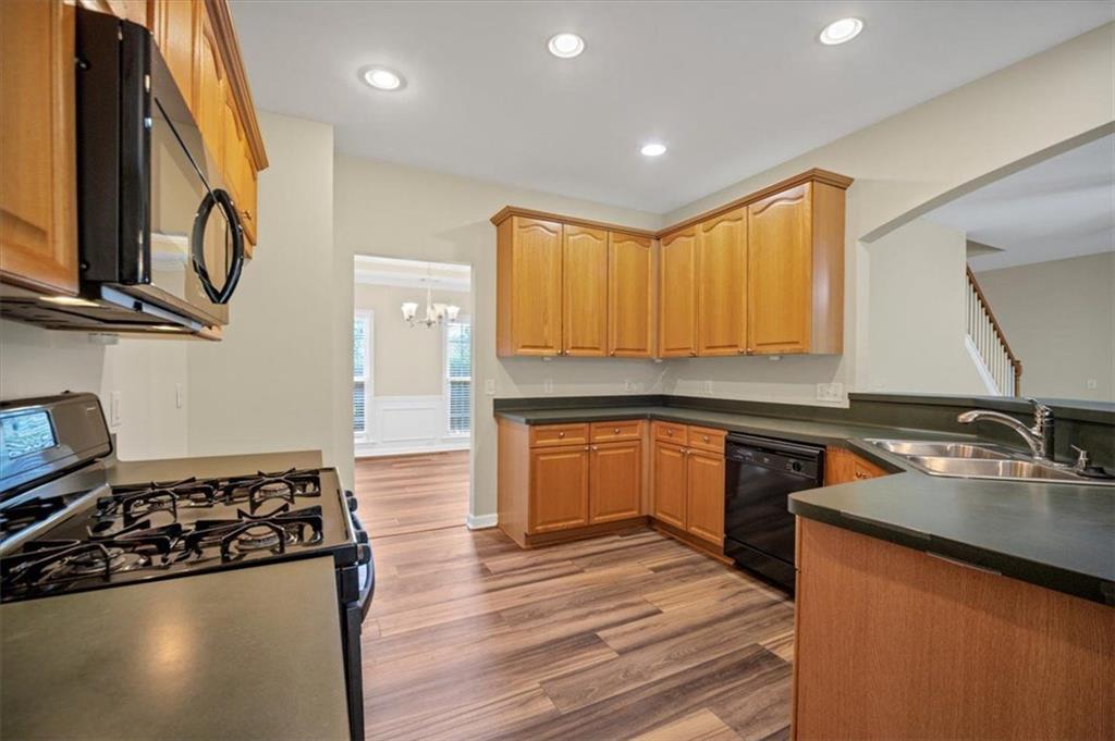 501 Middlebrooke Trace Canton, GA 30115 - Photo 15 of 29 a kitchen with stainless steel appliances granite countertop a stove a sink and a microwave