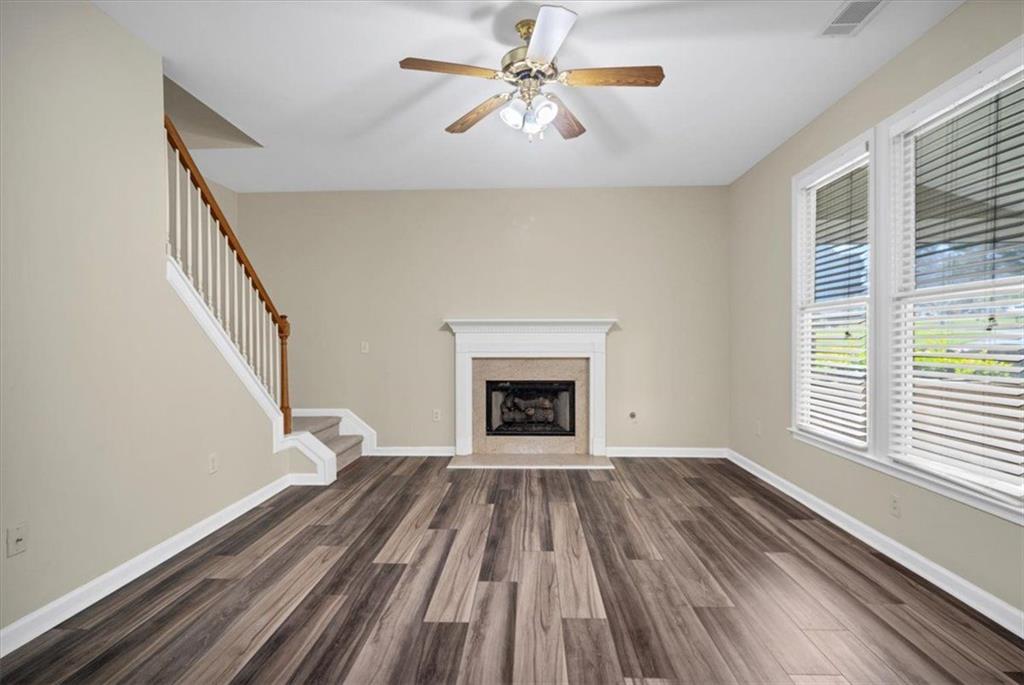 501 Middlebrooke Trace Canton, GA 30115 - Photo 21 of 29 a view of a livingroom with a fireplace a ceiling fan and windows