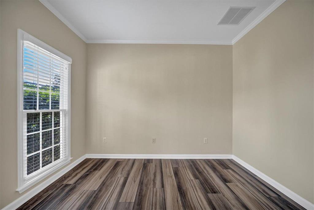 501 Middlebrooke Trace Canton, GA 30115 - Photo 6 of 29 a view of an empty room with wooden floor and a window