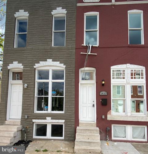 a front view of a building with a window and windows