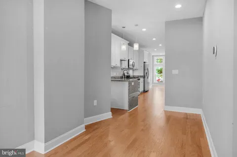 a view of a kitchen with a sink and wooden floor