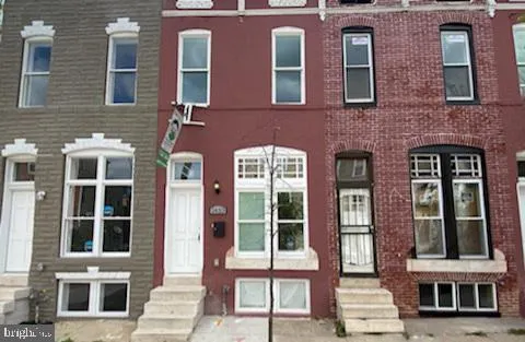 a front view of a brick building with many windows