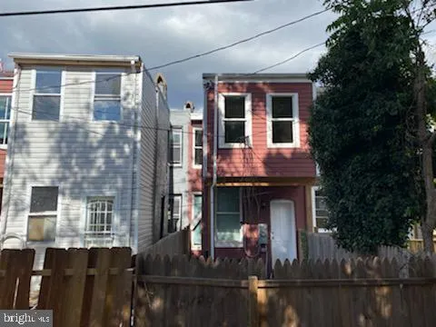 a view of a brick house with large windows and a table