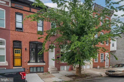 a front view of a building with trees