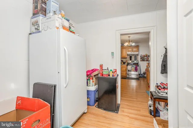 a view of a hallway with dining room and wooden floor