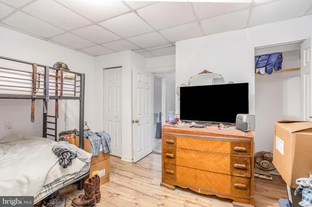 a bedroom with furniture and a flat screen tv