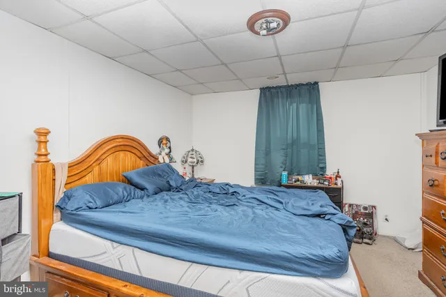 a bedroom with a bed and dresser