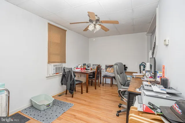 a view of a workspace with furniture and a chandelier