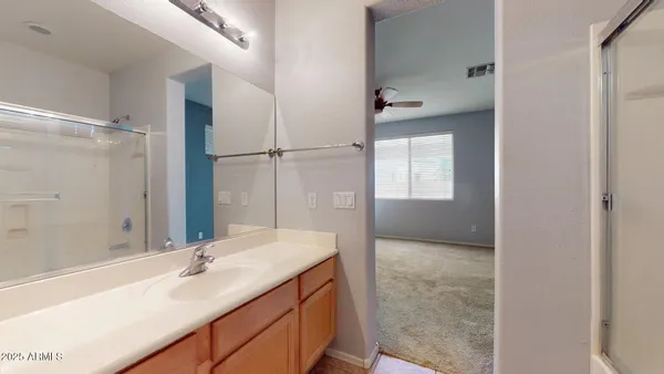 a bathroom with a granite countertop sink mirror and a bathtub