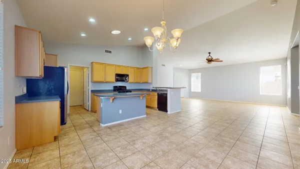 a large kitchen with cabinets and stainless steel appliances