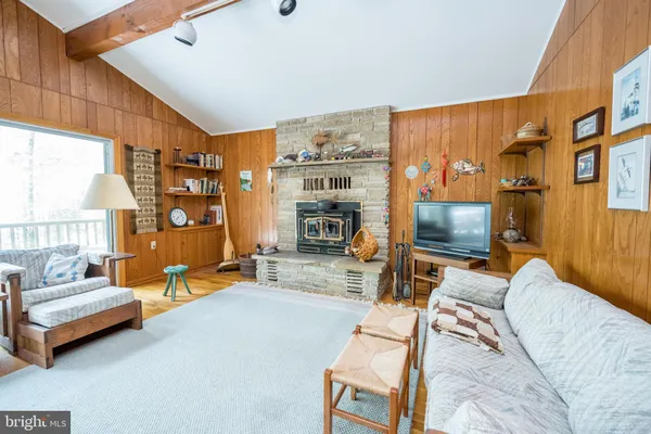 a bed sitting in a spacious bedroom next to a window