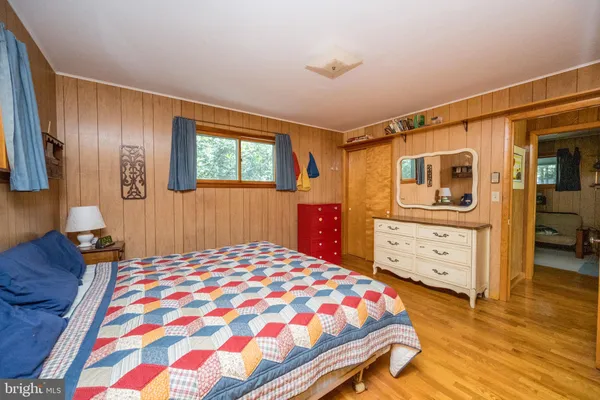 a bedroom with furniture and a window
