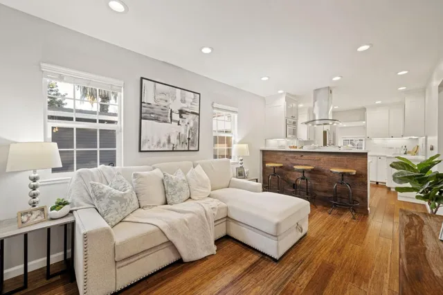 a kitchen with kitchen island a stove a table and chairs in it