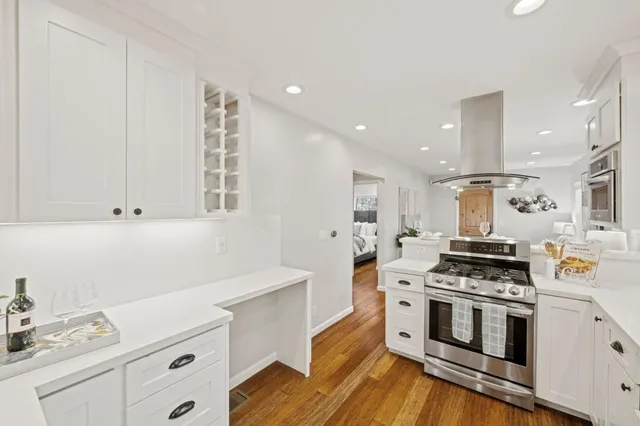 a kitchen with stainless steel appliances white cabinets and a sink