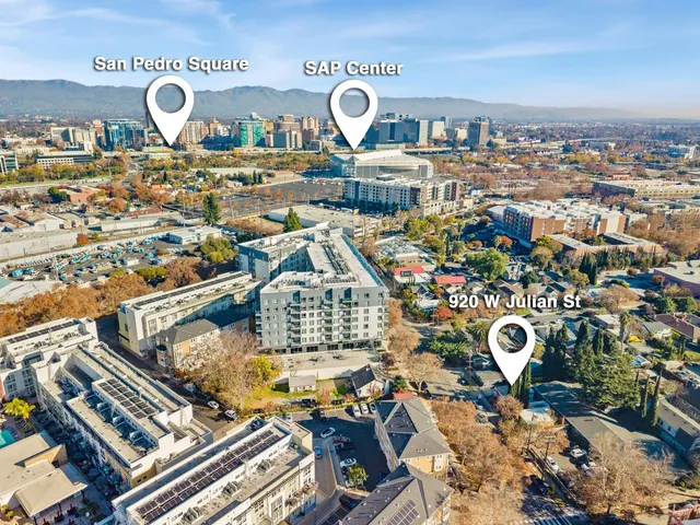 a aerial view of multi story residential apartment building with yard