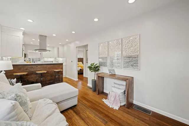 a living room with furniture a potted plant and a window