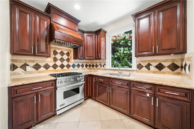 a large kitchen with kitchen island a large counter top stainless steel appliances and cabinets