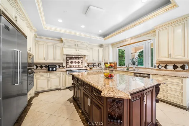 a kitchen with kitchen island granite countertop a sink window and refrigerator