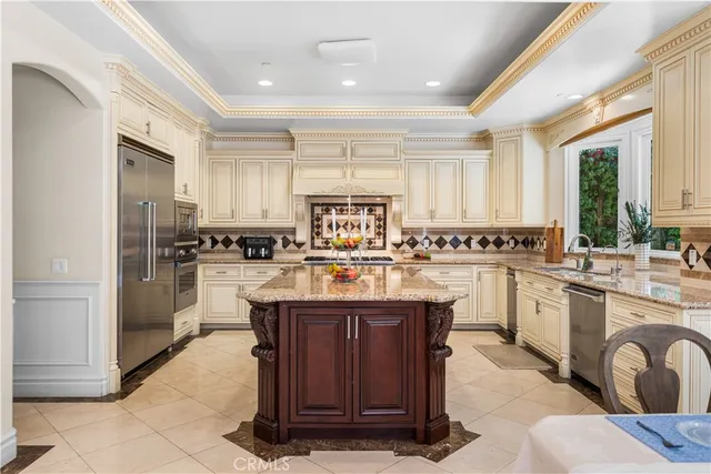 a kitchen with stainless steel appliances granite countertop a stove oven and a refrigerator
