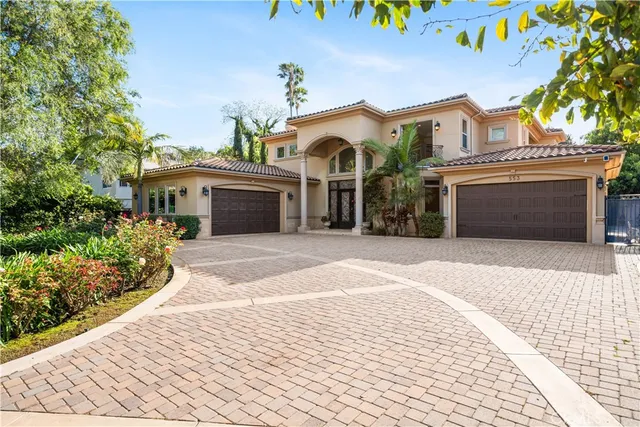 a front view of a house with a yard and a garage