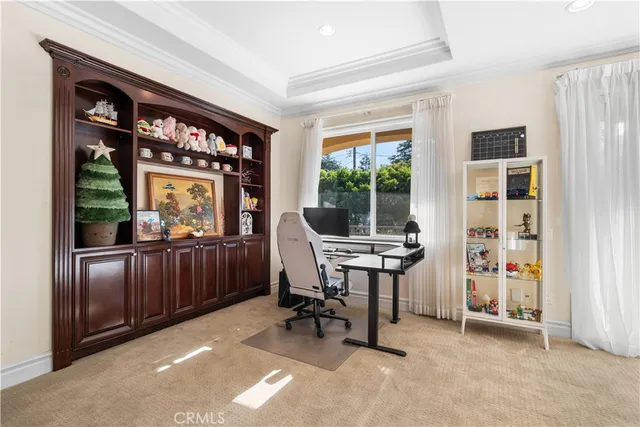 a large white kitchen with cabinets a washer dryer and a large window