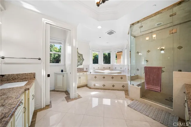 a large bathroom with a double vanity sink a mirror and a bathtub