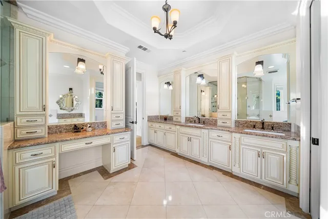 a spacious bathroom with double vanity sink a mirror a a bathtub and window
