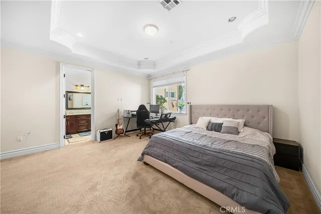 a spacious bedroom with a bed a table and a couch