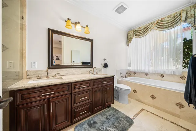 a bedroom with furniture and a flat screen tv