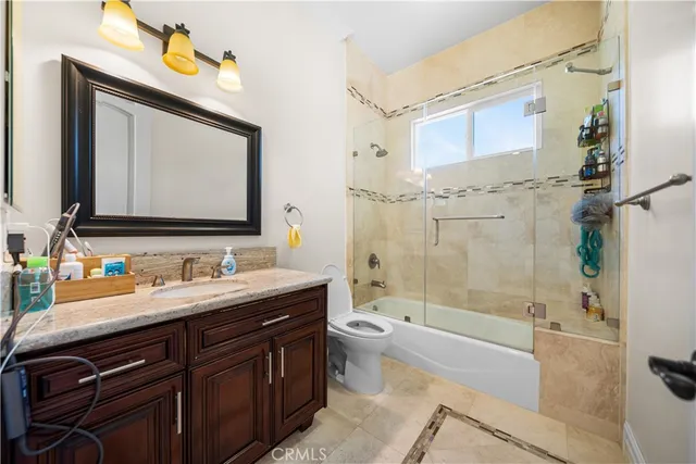 a kitchen with kitchen island granite countertop a stove and a sink