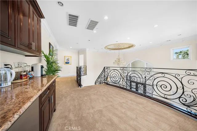 a bathroom with a granite countertop sink a toilet and a mirror