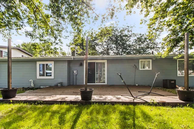 a front view of a house with a yard and swimming pool