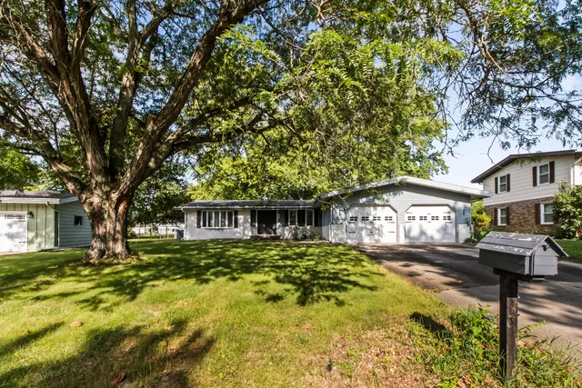 a house view with swimming pool and trees