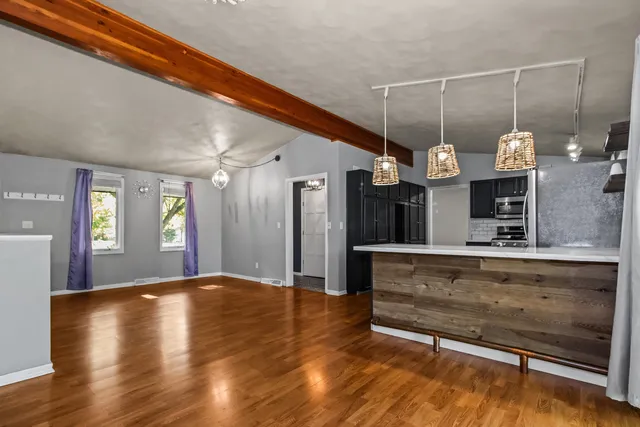 a view of a living room with hardwood floor and a ceiling fan