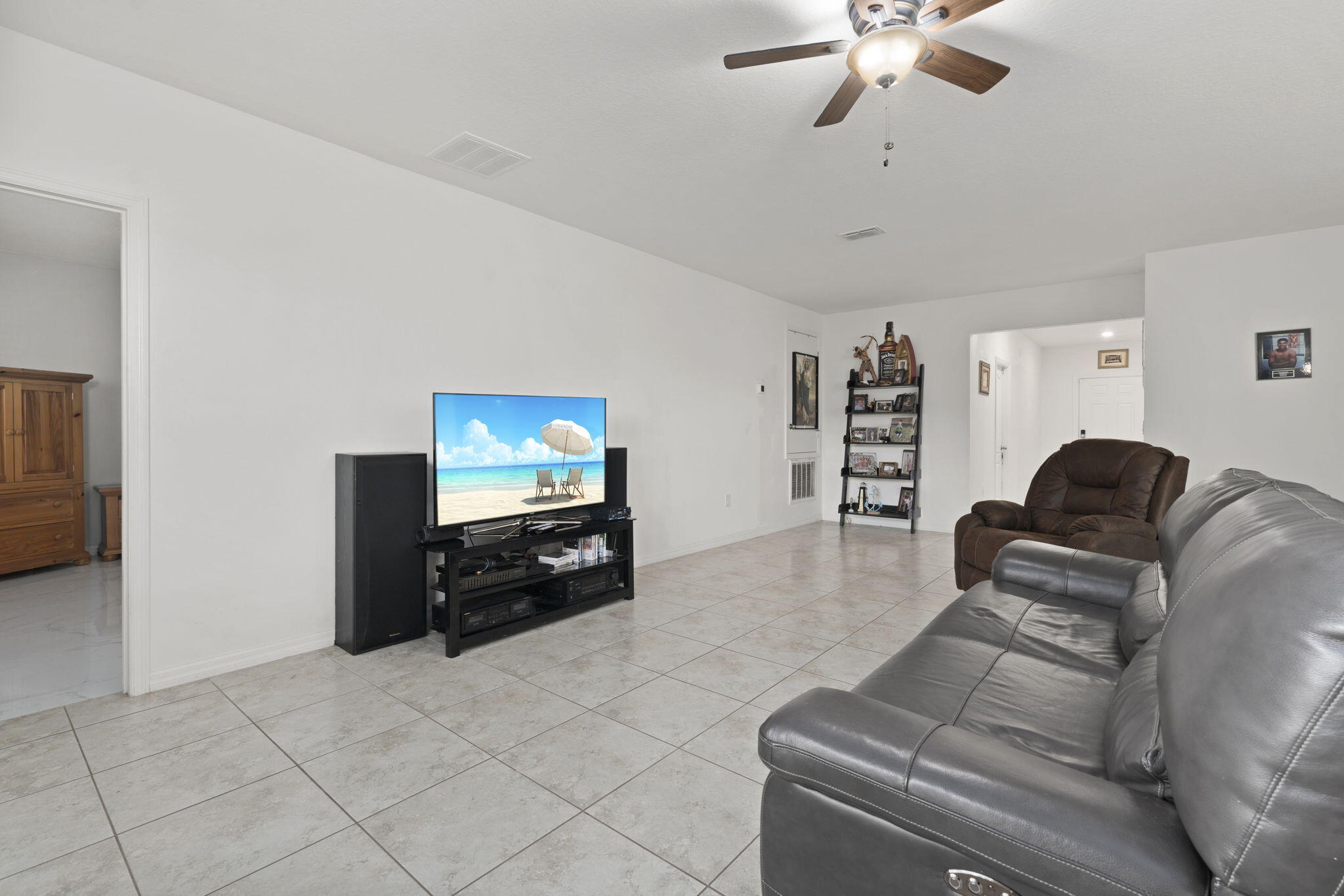 1414 Southwest Crest Avenue Port St. Lucie, FL 34953 - Photo 13 of 41 a living room with furniture and a flat screen tv